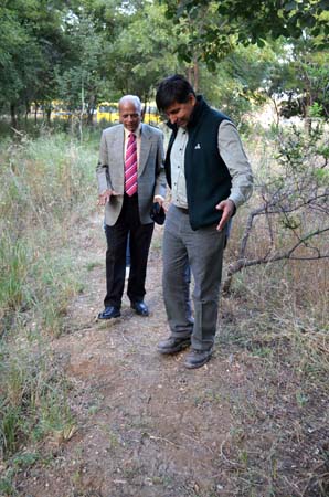 Brigadier and WIlliam looking at rain water tank in wild zone